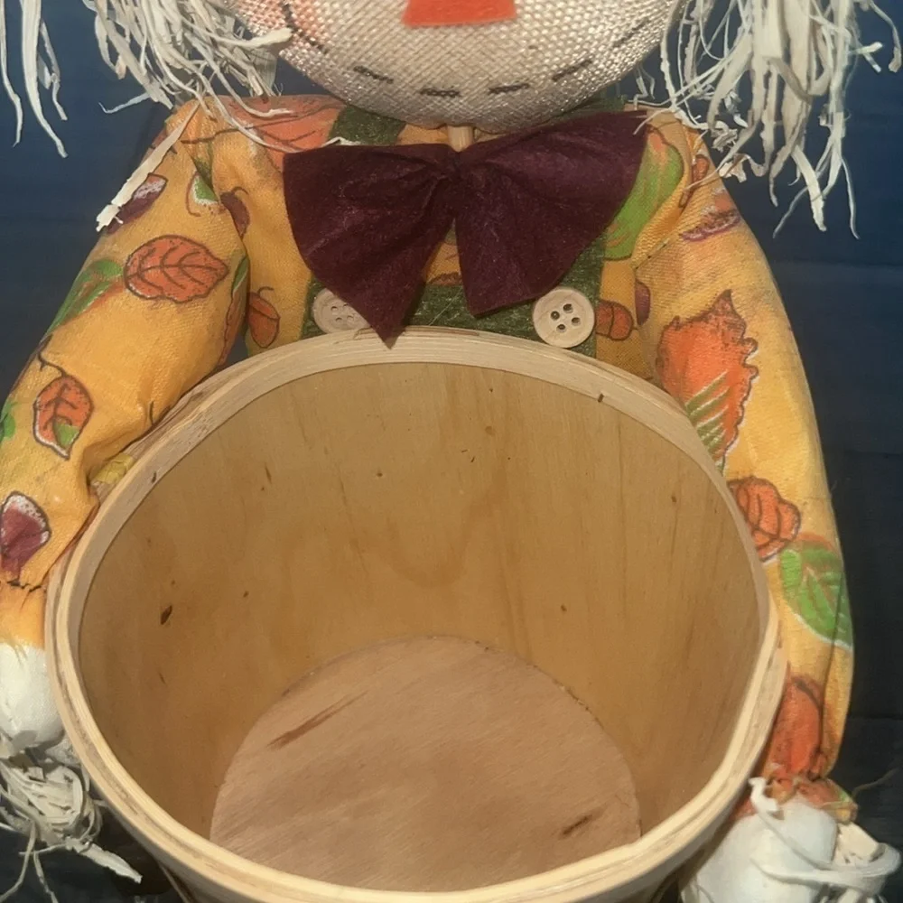 Scarecrow figurine with straw Bale